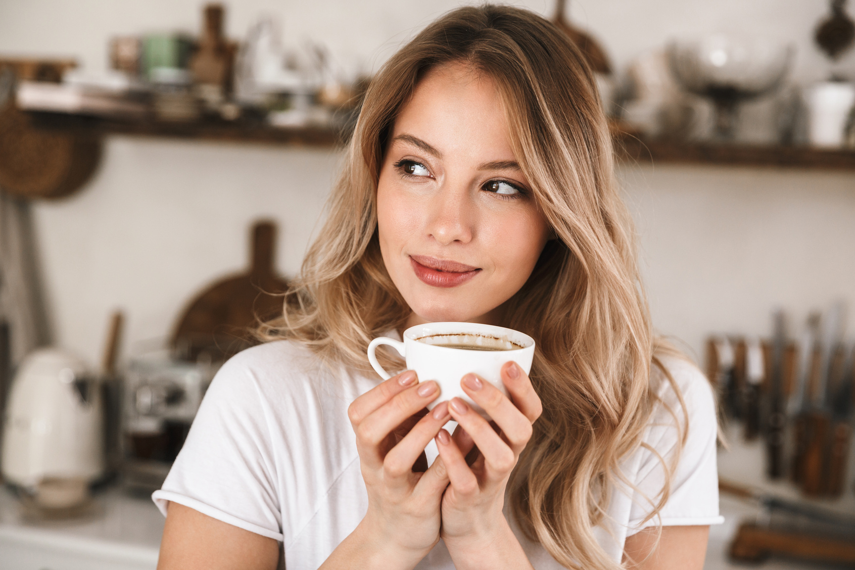 Woman Drinking Coffee in the Kitchen