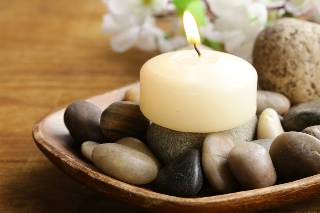 Lit Candle and Stones